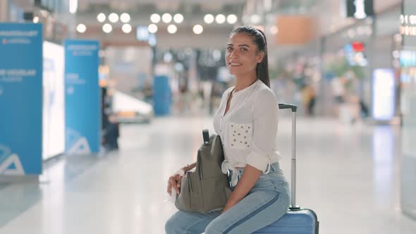 Passenger Smiling at Camera at Airport