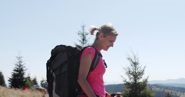 Woman Hiking in Mountains with Backpack, Enjoying Her Adventure. Slow Motion