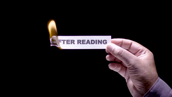 Hand Holds Paper Burning After Reading