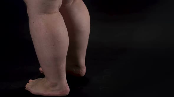 Obese Male Legs Turning Around Dark Background, Body Care, Unhealthy Nutrition