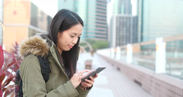 Woman use of smart phone in the city