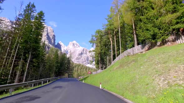 Beautiful winding road to the village Calfosch in the Dolomites in spring, Italy