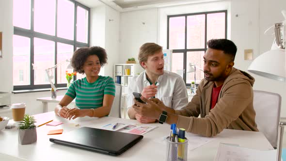 Man Showing Smartphone To Coworkers at Office 84