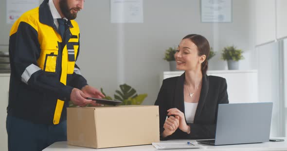 Young Businesswoman Receiving Parcel in Office