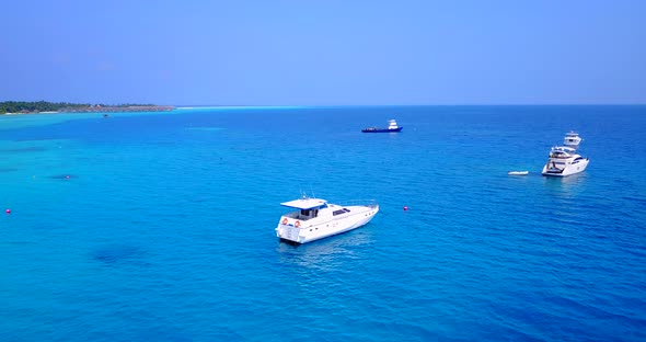 Wide angle birds eye copy space shot of a sunshine white sandy paradise beach and blue water backgro