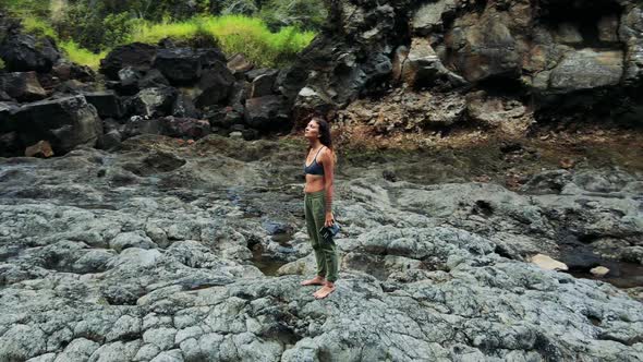 Aerial View of Beautiful Girl at the Waterfall on the Island of Hawaii