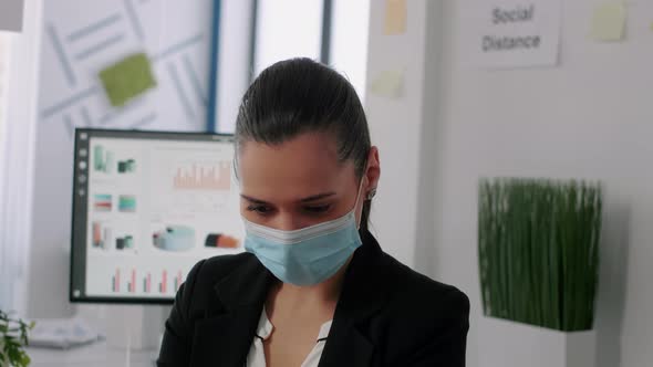 Portrait of Business Woman with Protective Face Mask Looking Into Camera