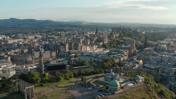 Slow descending drone shot of Calton hill Edinburgh at sunset