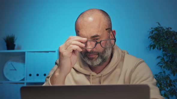 Stressed Overwhelmed Businessman Working on Computer Suffering From Eyes Fatigue or Having Painful