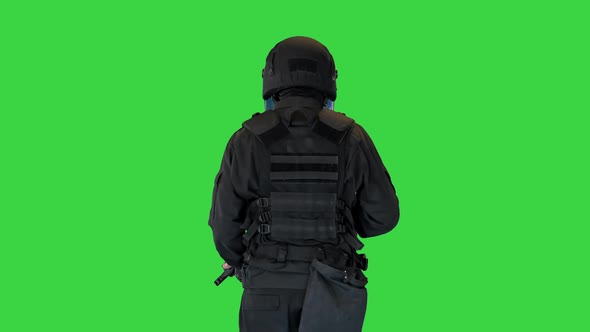 Police Tactical Unit with a Rifle Walking on a Green Screen Chroma Key