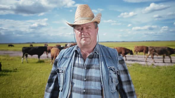 The rancher in a cowboy hat and denim. Portrait of a farmer