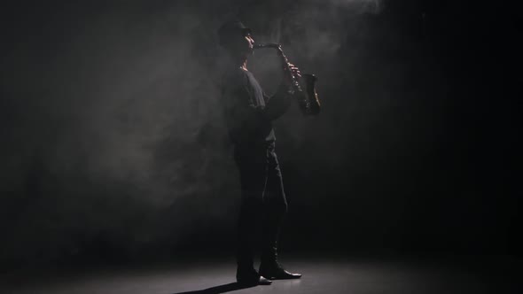 Music Saxophone. Performed By Man in a Dark Smoky Studio