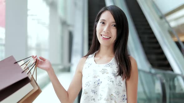 Happy woman holding shopping bags 