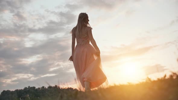 The Girl in the Dress Swirls Magically at Sunset.