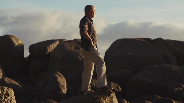 Senior man looking away at the beach