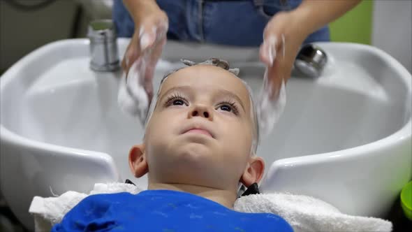 Parekhmacher, After Haircutting a Child of Preschool Age,wash Their Hair,soap with Shampoo,kid Lies