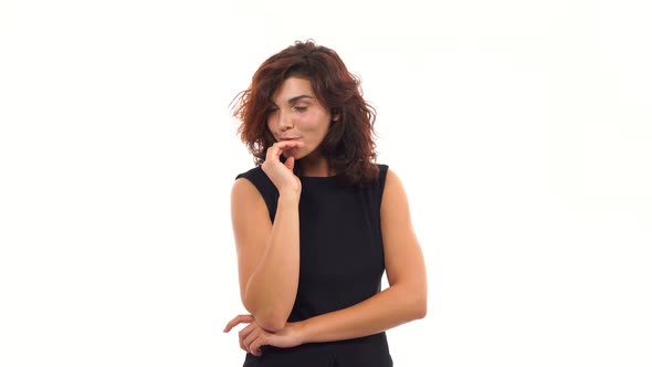 Attractive Young Woman Flirting and Touching Her Hair Isolated on a White Background