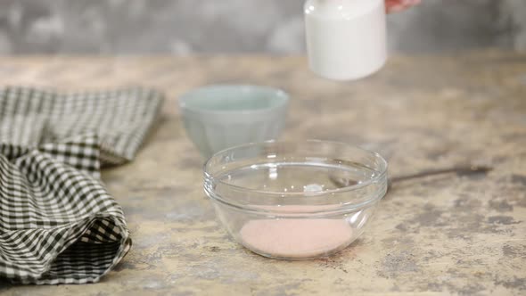 Woman on the kitchen making homemade jello from peach jelly powder.	