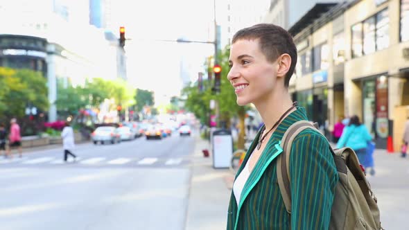 Woman in the city next to a busy road