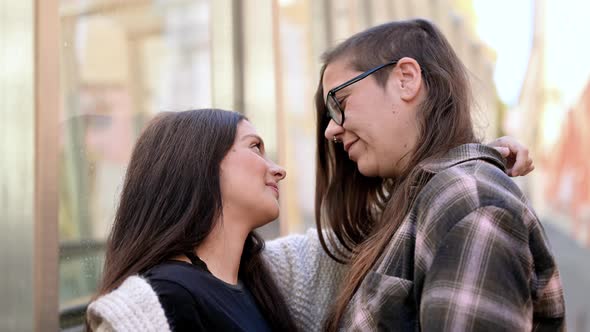 Young Affectionate Lesbian Couple Standing Outdoors in City