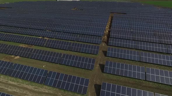 Massive Solar Power Station in the Field Drone is Flying Up Landscape