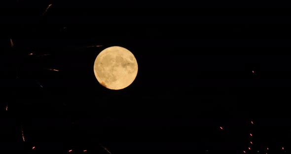 A firework in front of the Super full moon in the french sky