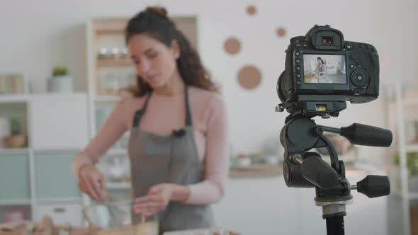 Camera Filming Blurred Culinary Vlogger