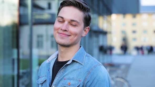 Happy Man Near Modern Office Building Outdoors