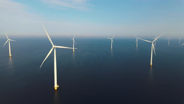 Offshore Windmill Park with Clouds and a Blue Sky Windmill Park in the Ocean Drone Aerial View with