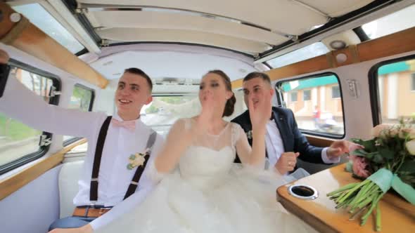 Bridesmaids and Groomsmen Dance While Sitting in the Limousine