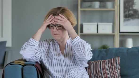 Tired Old Senior Woman Sitting with Headache Pain