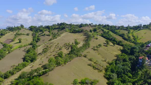 Lush Green Hills In El Caimito, Dominican Republic At Daytime - aerial drone shot