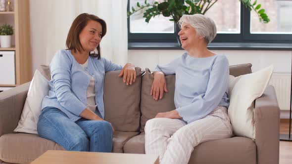 Senior Mother Talking To Adult Daughter at Home 