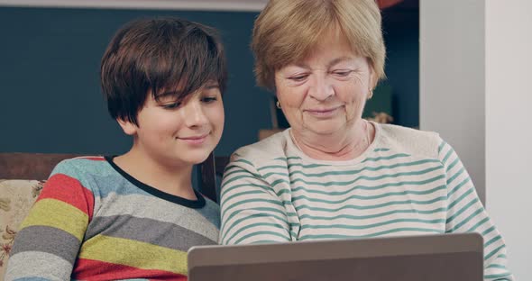 The Grandmother and the Grandson of the Teenager are Talking and Smiling