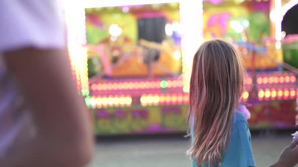 Little girl has fun at the fair with lights.