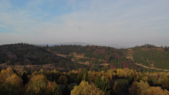 Flight over autumn mountains in the light of the setting sun