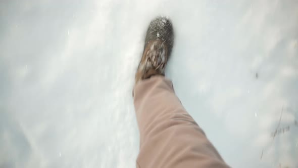 Man Legs Walking In Snow. Male In Snowy Weather At Cold Temperature Walking Alone. Legs Footprints.