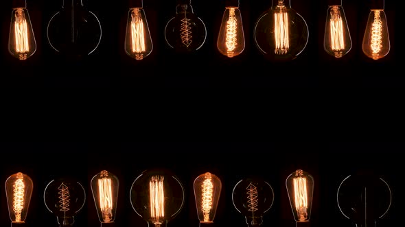 A Lot of Edison Bulbs Creating Great Background for Logo or Title. Blinking Lamps Black Background