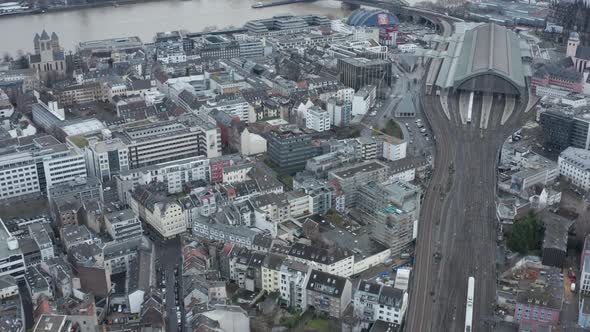 AERIAL: Over Cologne Railway Train System with Train Driving on Cloudy Day 