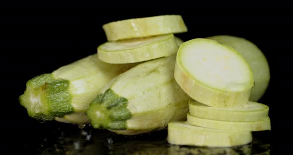 On Sliced and Whole Zucchini Falling Water Drops. 