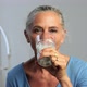 Mature woman drinking a glass of milk - VideoHive Item for Sale