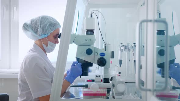 Female Scientist Looking Microscope Eyepiece. Portrait of Woman Scientist Looking Through Microscope