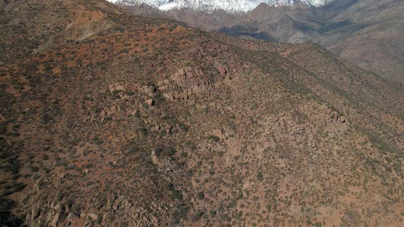 Aerial view dolly in tilt up of Morro Las Papas at San Carlos de Apoquindo Park in Las Condes, Santi