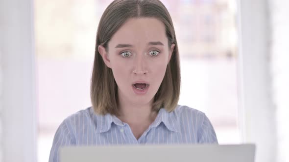 Portrait of Sleepy Young Woman Yawning in Office