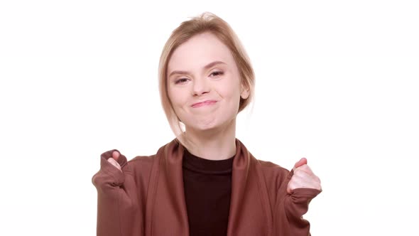 Attractive Teenage Girl Standing on White Background in Excitement and Smiling