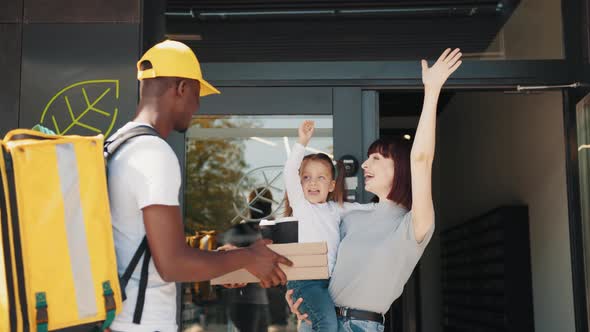 The Courier Delivers Lunch to a Beautiful Girl with a Child