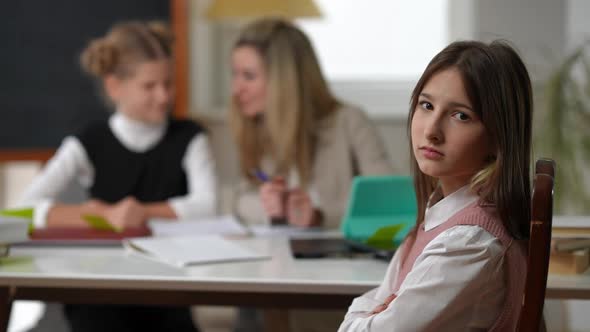 Sad Bored Schoolgirl Crossing Hands Sighing Looking at Camera with Dissatisfied Facial Expression As