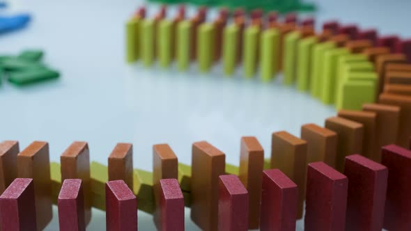 Line up of Dominoes in Rainbow Falling Colors with LGBT Colors of a Hand