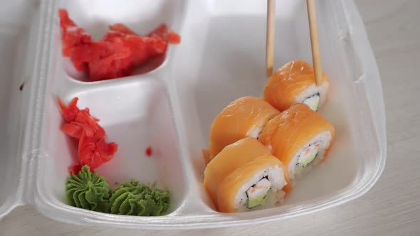 Man Dips Amazing Bright Philadelphia Roll in Soy Sauce