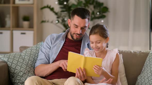 Happy Father and Daughter Reading Book at Home 31